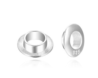 May include: Two silver jump rings with a textured surface. The ring on the right has the number 925 stamped on it.