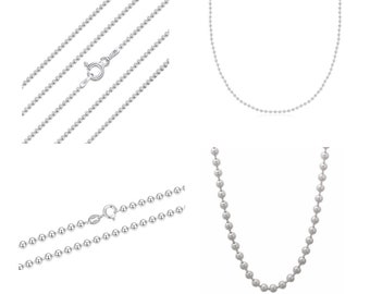 May include: Three silver ball chain necklaces of varying lengths. The chains are made of small, round beads.