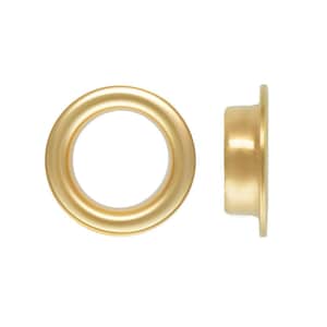 May include: A gold-colored metal grommet shown from two perspectives: a front-facing view displaying a circular opening with a smooth, rounded rim, and a side-profile view revealing the cylindrical shaft and the flat, circular flange edge.