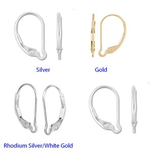 May include: Four pairs of earring hooks in silver, gold, and rhodium silver. The hooks are all the same style, with a small loop at the top and a hook at the bottom.