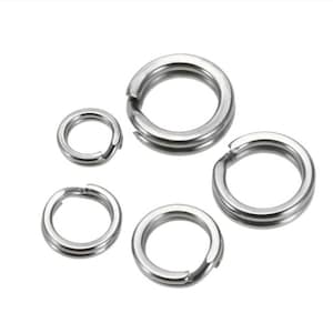 May include: Five silver metal rings of different sizes. The rings are smooth and have a polished finish.