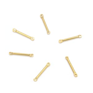 May include: Six gold-toned metal connector bars with two loops on each end. The bars are scattered on a white background.