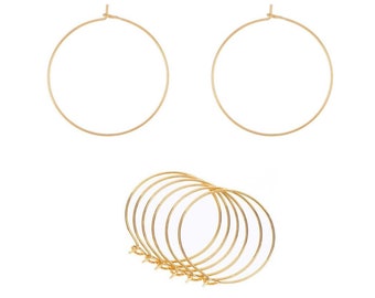 May include: A set of six gold hoop earrings. The earrings are simple and elegant, and they would make a great gift for any occasion.