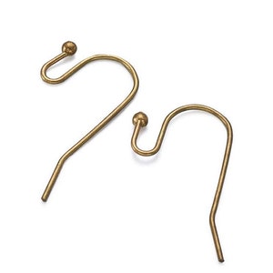 May include: Two gold-toned earring hooks with a small ball at the top of each hook.