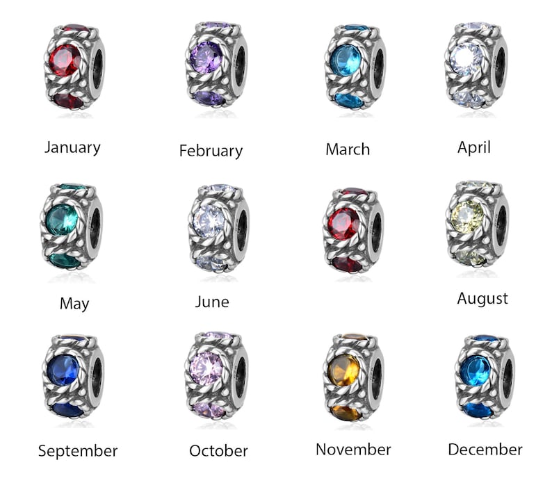 May include: Twelve silver charm beads with different coloured crystals, representing each month of the year. January is red, February is purple, March is blue, April is white, May is green, June is clear, July is red, August is yellow, September is blue, October is pink, November is yellow, and December is blue.
