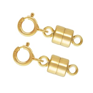 May include: Two gold-colored magnetic clasps for jewelry making. Each clasp has a round spring ring, a small connecting loop, and a cylindrical magnetic closure. The clasps are shown against a white background.