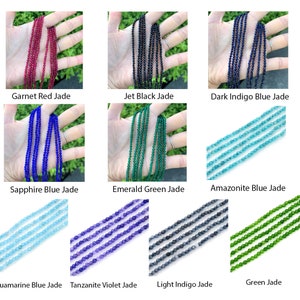 May include: A collection of 10 strands of gemstone beads, each strand is a different color. The colors include red, black, dark blue, blue, green, light blue, purple, gray, and light green. The beads are all round and smooth.