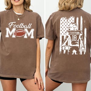 A woman wearing a brown t-shirt with the text "Football Mom" printed on it, along with an image of a football player.