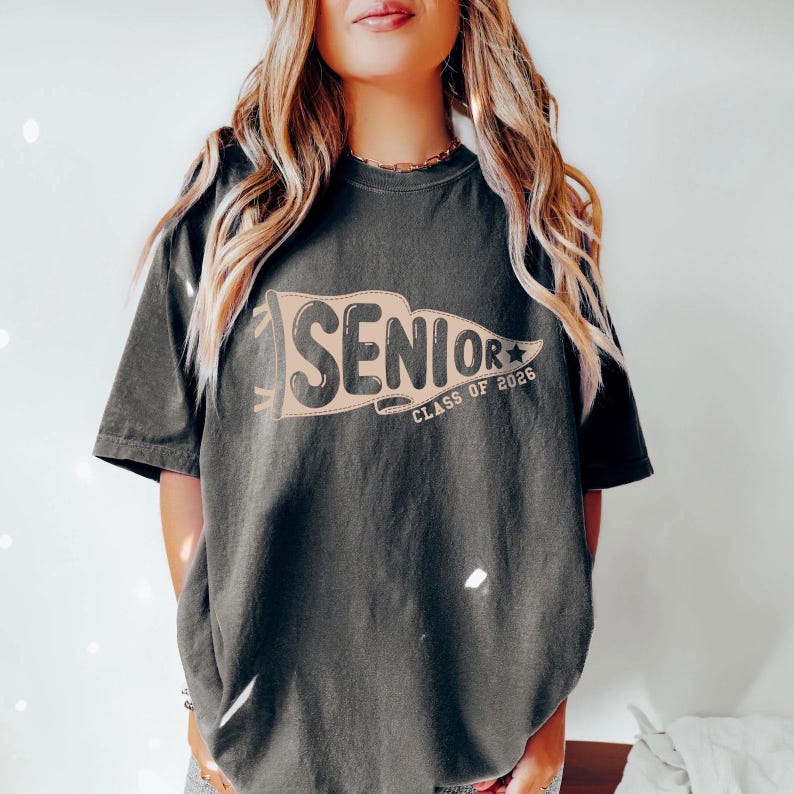 A woman wearing a black t-shirt with the text "SENIOR CLASS OF 2006" printed on it.