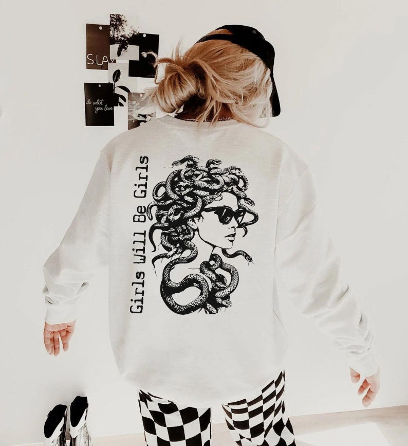 a woman wearing a white sweatshirt and checkered pants