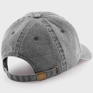 A gray, vintage-style baseball cap with a metal buckle.