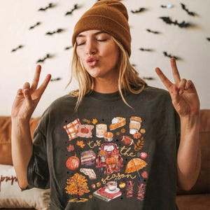 a woman sitting on a couch making a peace sign