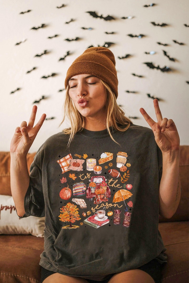 a woman sitting on a couch making a peace sign