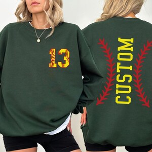 a woman wearing a green sweatshirt with the number thirteen on it