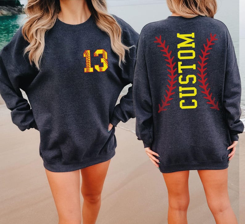 two women wearing matching sweatshirts on the beach