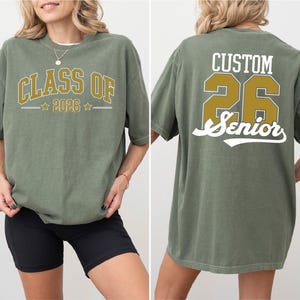 a woman wearing a green t-shirt with text and numbers printed on it.