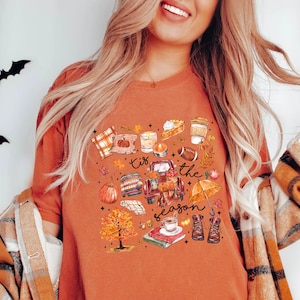 a woman wearing an orange shirt and a plaid cardigan