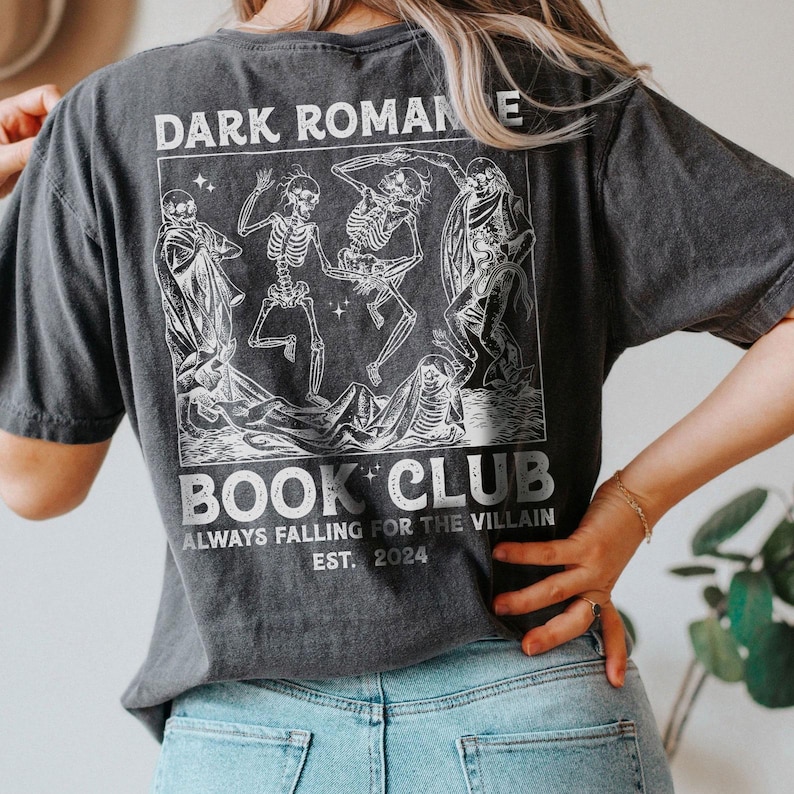 a woman wearing a dark romane book club t - shirt