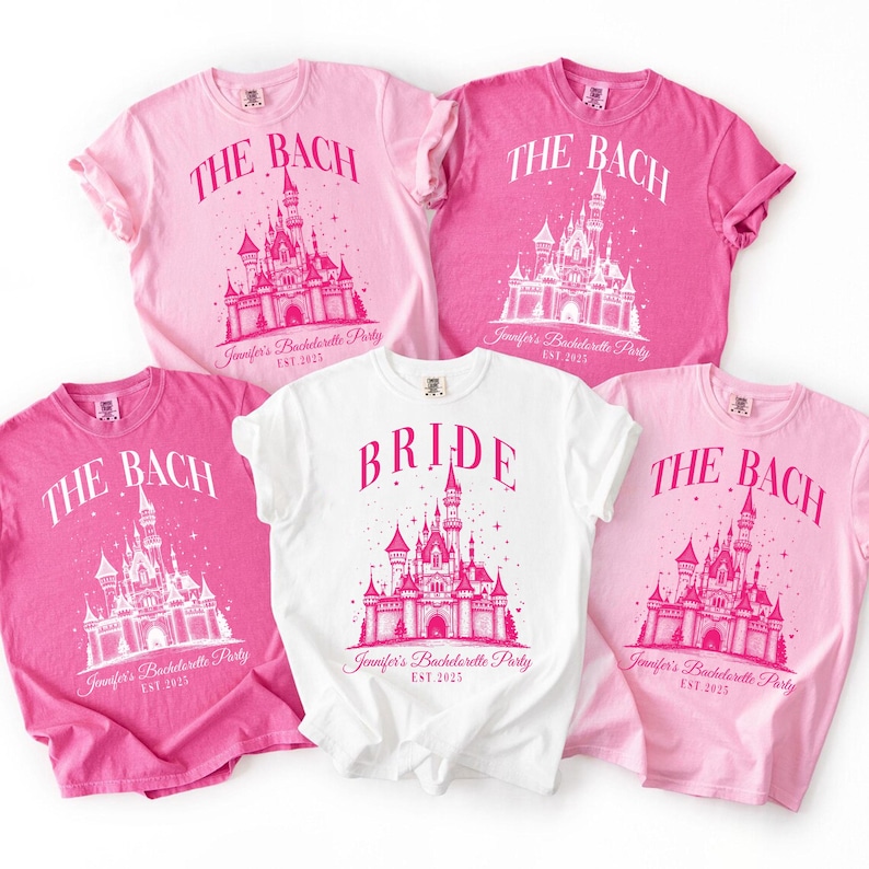 a collection of pink and white t-shirts with the text "The Bach" and "Bridal" printed on them, along with a castle illustration.