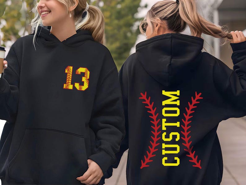two women walking down the street wearing matching sweatshirts