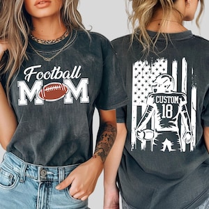 two women wearing black t-shirts with football-related designs.