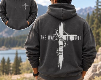 May include: A charcoal grey hooded sweatshirt featuring a white graphic on the back of a cross wrapped in a crown of thorns with the text THE WAY THE TRUTH THE LIFE. A smaller version of the same cross graphic is printed on the front left chest.