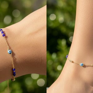 May include: A delicate gold chain bracelet and anklet featuring small, vibrant blue beads and a central evil eye charm. The evil eye charm is designed with a light blue iris, a black pupil, and a white background, set within a gold-toned frame.