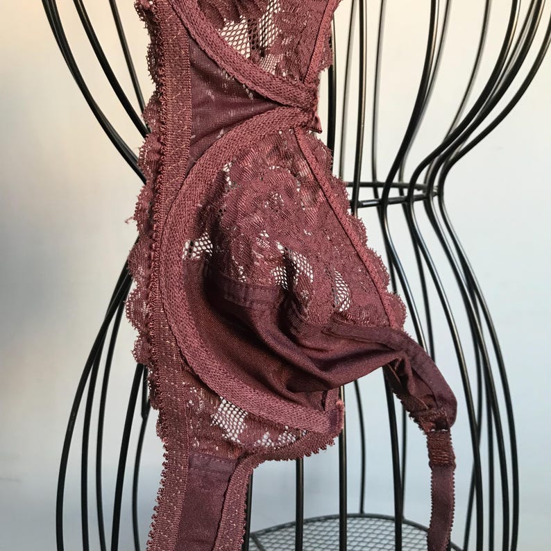 May include: A burgundy lace bra with adjustable straps and a hook and eye closure.