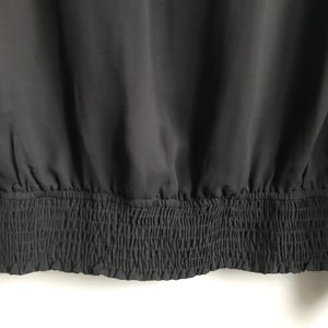 May include: Black top with a gathered elastic waistband.