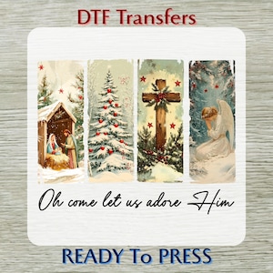 May include: DTF Transfers featuring four rectangular designs with Christmas themes. The designs include a nativity scene, a decorated Christmas tree, a cross, and an angel. The text "Oh come let us adore Him" is written in cursive. The words "READY To PRESS" are also visible.