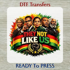 May include: DTF Transfers design featuring portraits of historical figures with the text "THEY NOT LIKE US" on a ribbon with the colors of the Pan-African flag. The design includes a clenched fist and the words "READY TO PRESS".