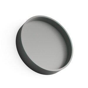 May include: A gray, circular tray with a raised edge. The tray is a solid color and appears to be made of a smooth material. The design is minimalist and modern, suitable for serving or display.