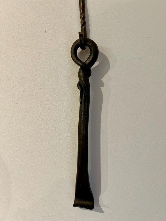 A blacksmith actually hammered this from raw steel — every one is unique, functional, and looks like it belongs in a Viking longhouse.