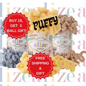 May include: Three balls of yarn in different colors: light blue, beige, and yellow. The yarn is fluffy and textured. The yarn is labeled "Alize Puffy" and there is a red banner that says "Buy 15, Get 3 Ball Gift" and another red banner that says "Free Shipping & Gift".