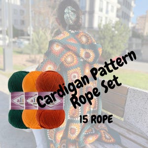 May include: Three skeins of yarn in green, orange, and rust colors. The yarn is labeled "ali Cotton Blend". The yarn is next to a crocheted cardigan with a green, orange, and rust color pattern. The text "Cardigan Pattern Rope Set 15 Rope" is superimposed on the image.