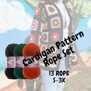 Peut inclure: Trois pelotes de fil noir, vert et orange. Le fil est étiqueté "Alize Cotton Gold" et est destiné au crochet. L'image montre également un cardigan crocheté avec une étiquette "Cardigan Pattern Rope Set" et le texte "13 Rope S-3X".