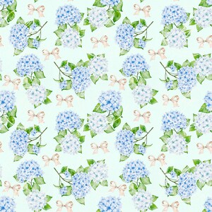May include: A repeating pattern of watercolor blue and white hydrangea flowers with green leaves and small peach bows on a light green background. The floral design is suitable for fabric, wallpaper, or other decorative applications.