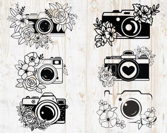 May include: Five black and white camera illustrations with floral designs. Each camera has a heart, lens, and shutter. The floral designs are different for each camera.
