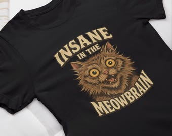May include: Black t-shirt with a graphic of a cat with wide eyes and an open mouth. The text "Insane in the Meowbrain" is printed on the shirt.