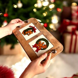 May include: A wooden serving tray with two removable ceramic tiles. Each tile features a cartoon bear wearing a green wreath with a red bow. The tray has two silver handles.