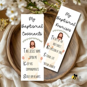May include: Two white bookmarks with religious text and illustrations. One bookmark reads "My Baptismal Covenants" with text below and an image of Jesus. The other bookmark reads "My Baptismal Promises" with text and an image of Jesus.