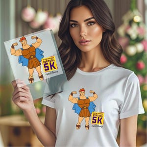 May include: White t-shirt featuring a cartoon illustration of Hercules flexing his muscles. The design includes a blue cape, brown skirt, and the text "GO THE DISTANCE VIRTUAL 5K runDisney" in yellow and purple. The same design is also on a clear plastic sheet.