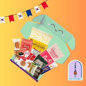 May include: A light green open cardboard box filled with various Korean snacks, including packages labeled Honey Butter Corn Snack, Yogurt Jelly, and French Pie. A sticker featuring a tower and the text SOUTH KOREA is placed nearby.