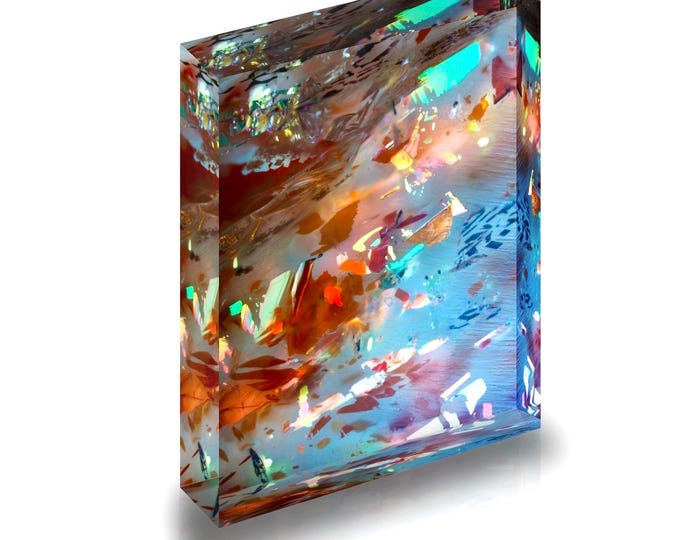 Print of crystals in the mineral Sunstone displayed in acrylic block.