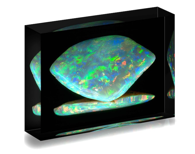 Print of 318 carat Dark Jubilee Opal from Smithsonian Museum displayed in acrylic block.