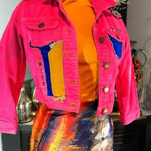 Pink denim jacket with embroidery and embellishments