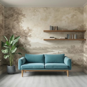May include: A teal blue sofa with wooden legs sits in a room with a landscape mural. A large potted plant and two wooden shelves with books are also present. The room has a light gray floor and a window.