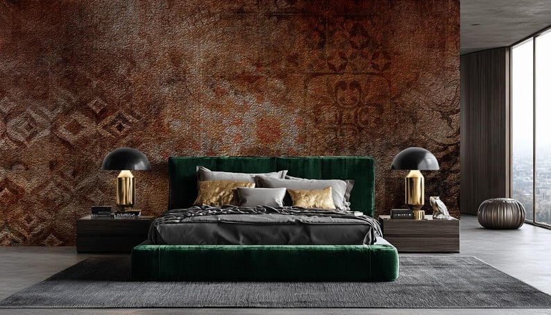 May include: A luxurious bedroom featuring a dark green velvet bed with gray and gold pillows and bedding. Two black and gold lamps sit on dark wood nightstands. The room has a textured brown wall and a gray rug.
