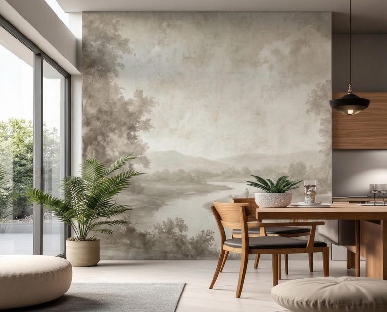 May include: A modern dining room with a large landscape mural on the wall. The room features a wooden dining table and chairs, a potted plant, and a large window. The color palette is neutral with shades of brown and gray.