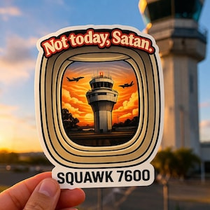 May include: A sticker with the text "Not today, Satan" in a red and white font, with a stylized image of an airport control tower. The sticker also includes the text "SQUAWK 7600". The background shows a sunset and a control tower.